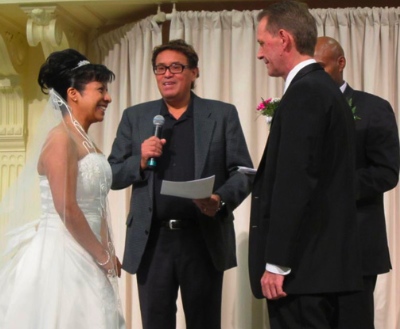 Elsa and John at their wedding. Rene Gallegos, outreach worker at UGM was officiating the ceremony in Spanish. Beside him is Jemal Damtawe, also an outreach worker at UGM, who officiated in English.