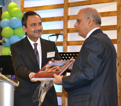 The Pakistani  Consul-general in Vancouver, Shujah Alam (left) presenting a book featuring churches in Pakistan to Balbir Sheena of the Punjabi Masihi pastoral team.