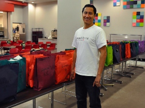 Sean Clark, co-founder of SHOEme, with last year's donation of shoes to UGM.