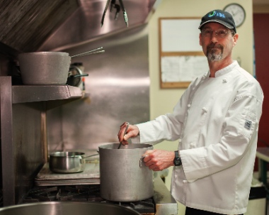 Mike Miller has run the kitchen at UGM New Westminster for 19 years; he will tell his story at the 75th anniversary gathering.
