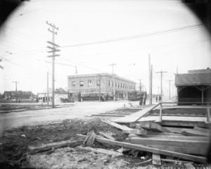  View of 41st Avenue, looking west from East Boulevard, probably in 1914. Photograph shows interurban line, municipal hall for Point Grey, and various businesses, including the Bank of British North America. Vancouver Archives: AM54-S4-: LGN 1012 