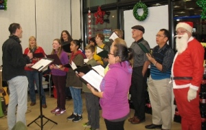 Pastor Paul Dirks leading members of New West Community Church singing Christmas carols at 7-Eleven Sapperton.