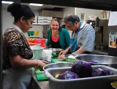 Karen Giesbrecht (centre) and volunteers preparing a meal at Tenth Church. She is one of the organizers of Famine or Feast.